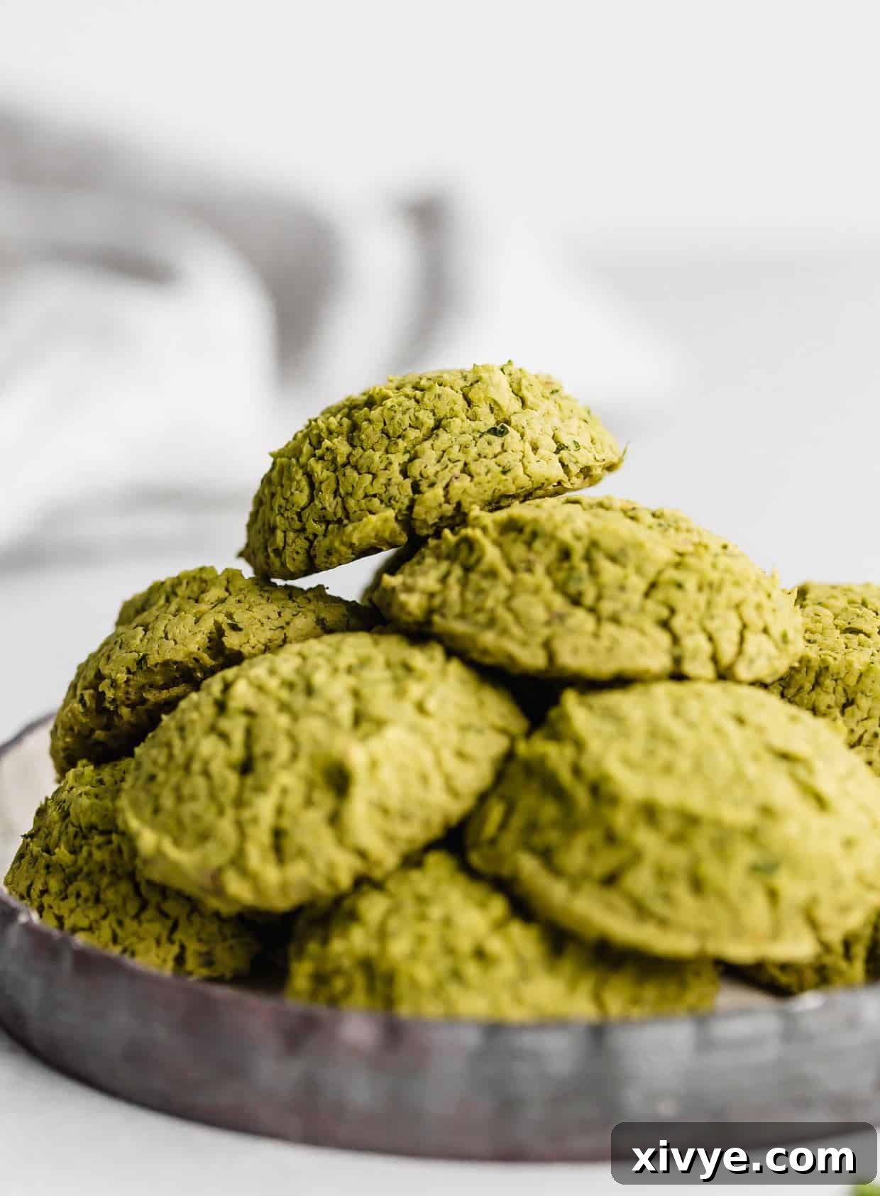Baked Falafel on a black plate against a white background.