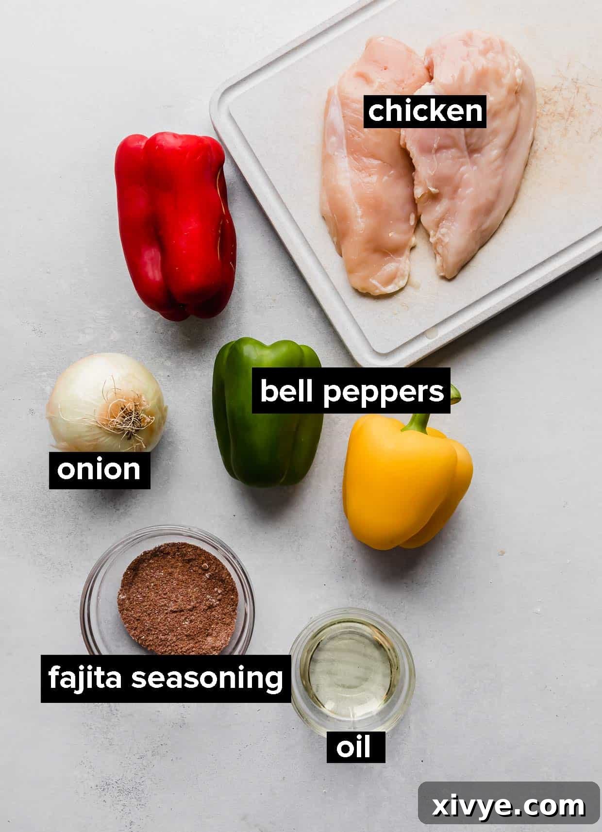 A vibrant sheet pan of cooked chicken fajitas, bursting with colorful peppers and onions.