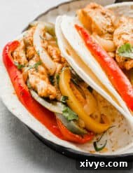 A sheet pan chicken fajita on a plate.