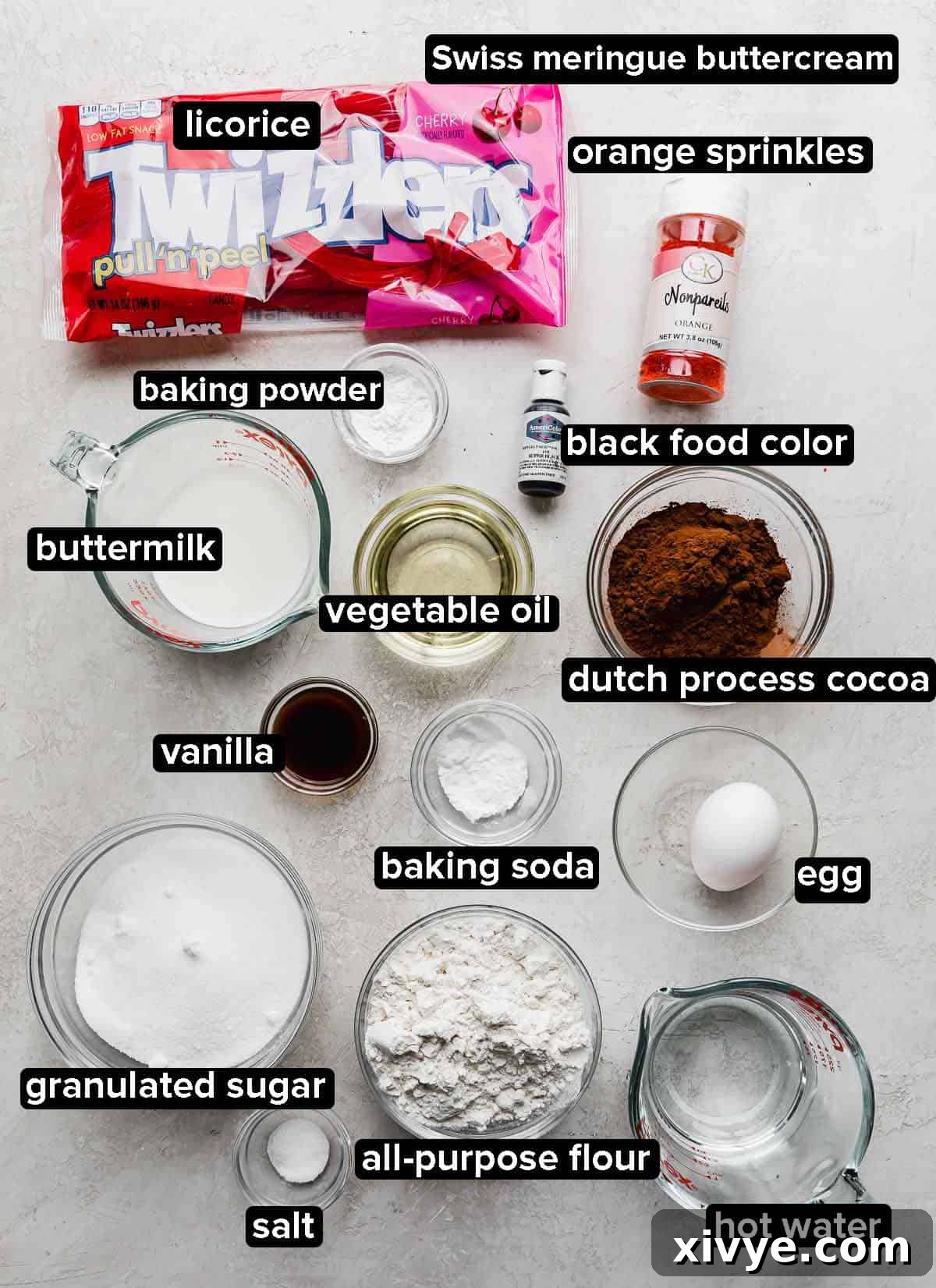 Slam Dunk Sweets 3 Collection of ingredients for Basketball Cupcakes laid out on a light grey background, including flour, cocoa powder, sugar, butter, eggs, milk, and sprinkles.