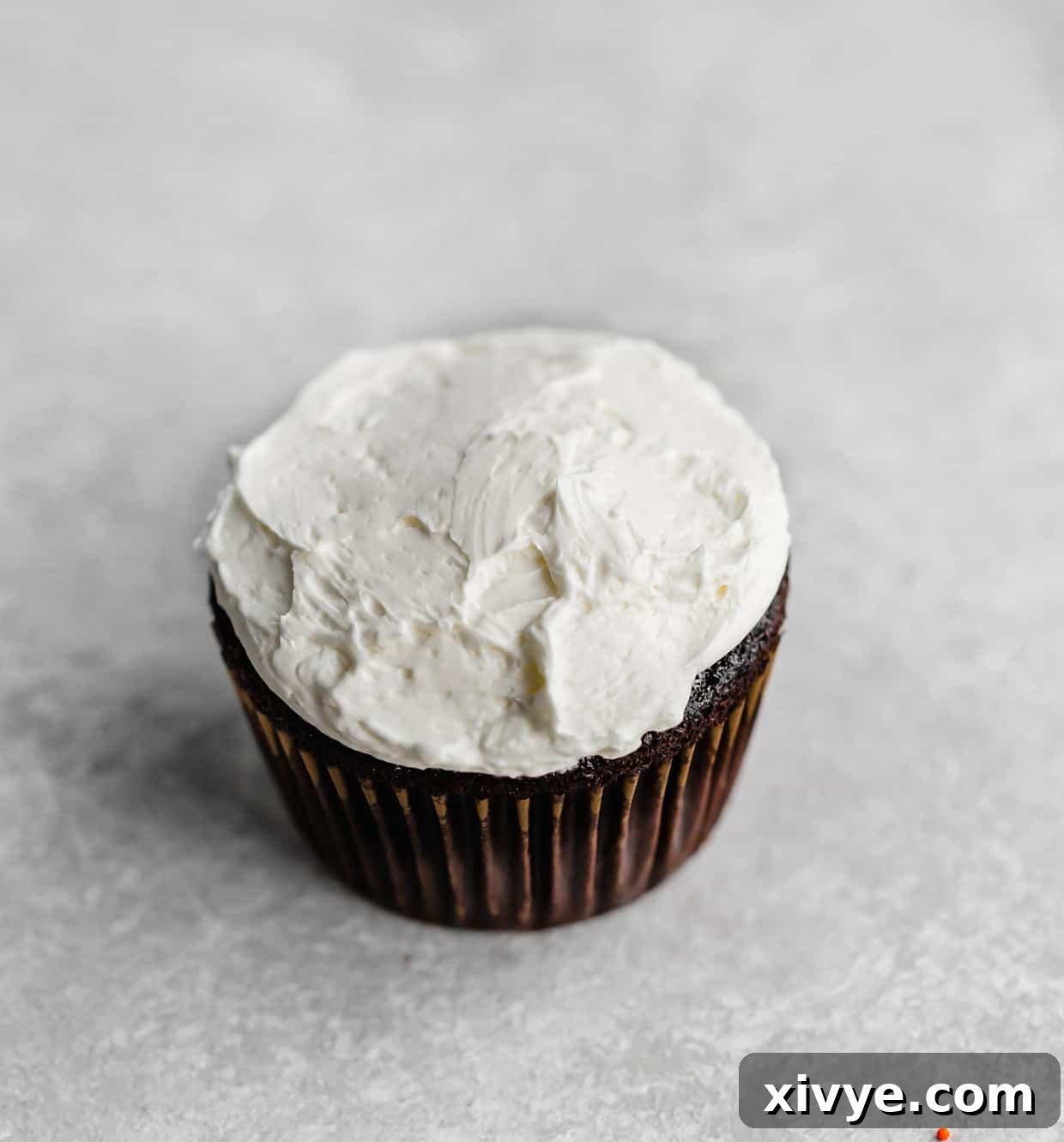 Slam Dunk Sweets 4 A chocolate cupcake expertly frosted with smooth Swiss meringue buttercream, ready for the next step of decoration.
