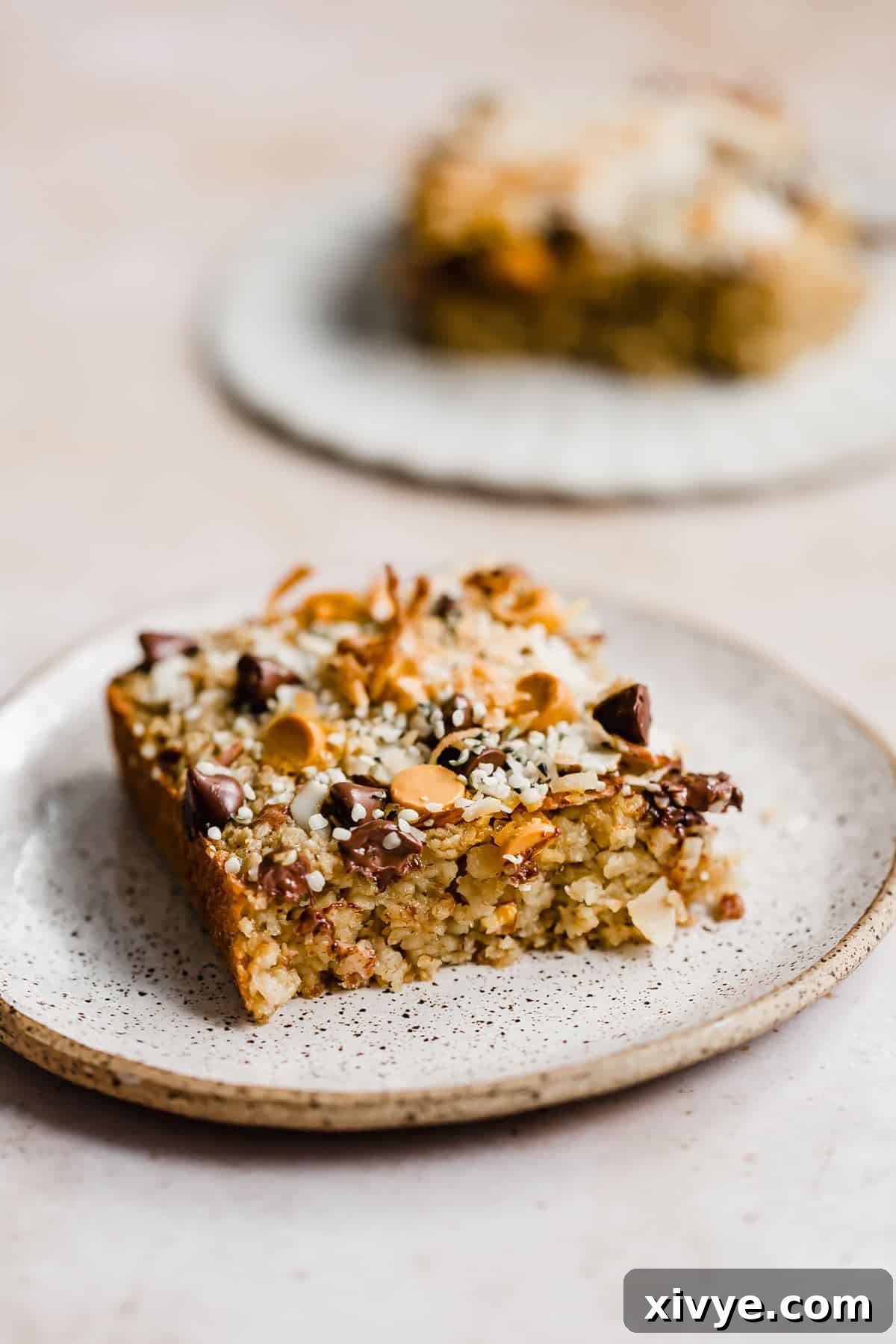 A square slice of Breakfast Baked Oatmeal Cake on a plate, ready to be enjoyed as a delightful breakfast or snack.