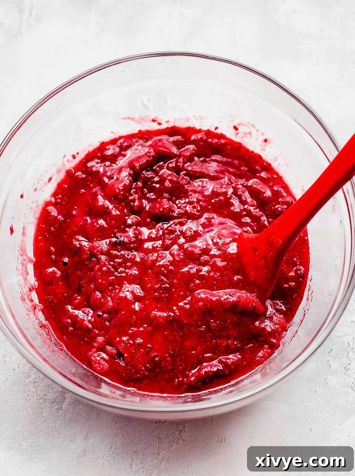 No-Fuss Raspberry Freezer Jam 6 A red raspberry sauce in a glass bowl.
