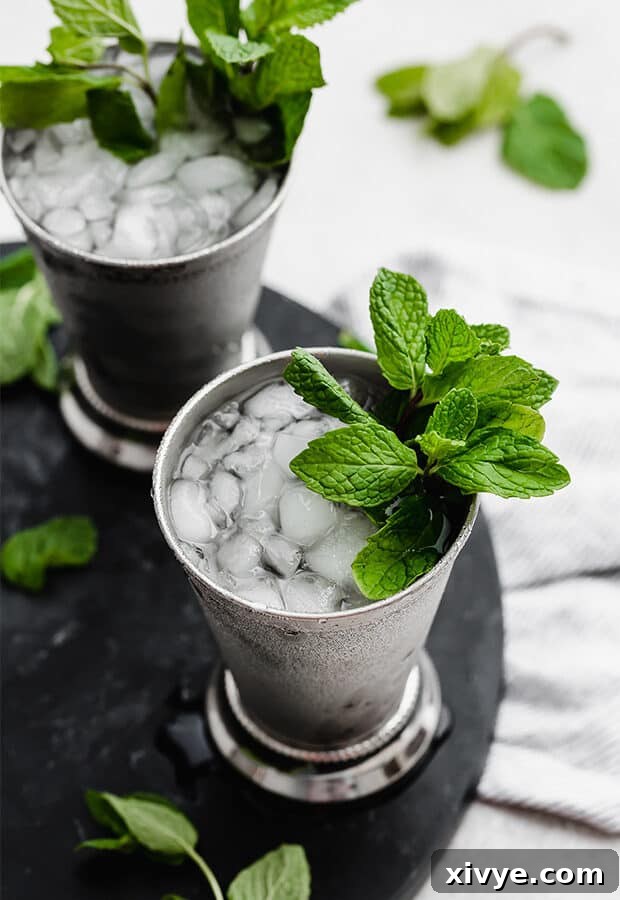 Zero-Proof Mint Julep 2 A virgin mint julep in a silver cup with a sprig of mint.