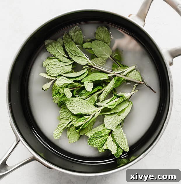 Zero-Proof Mint Julep 4 A saucepan with sugar, water, and mint leaves.