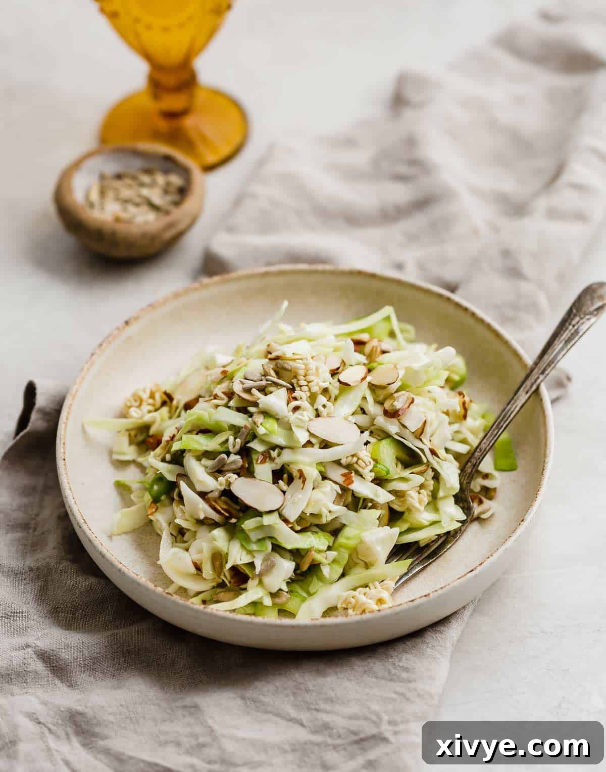 Crunchy Cabbage Salad recipe on a tan plate.