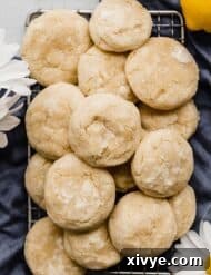 Lemon Cookies covered in powdered sugar on a blue napkin.