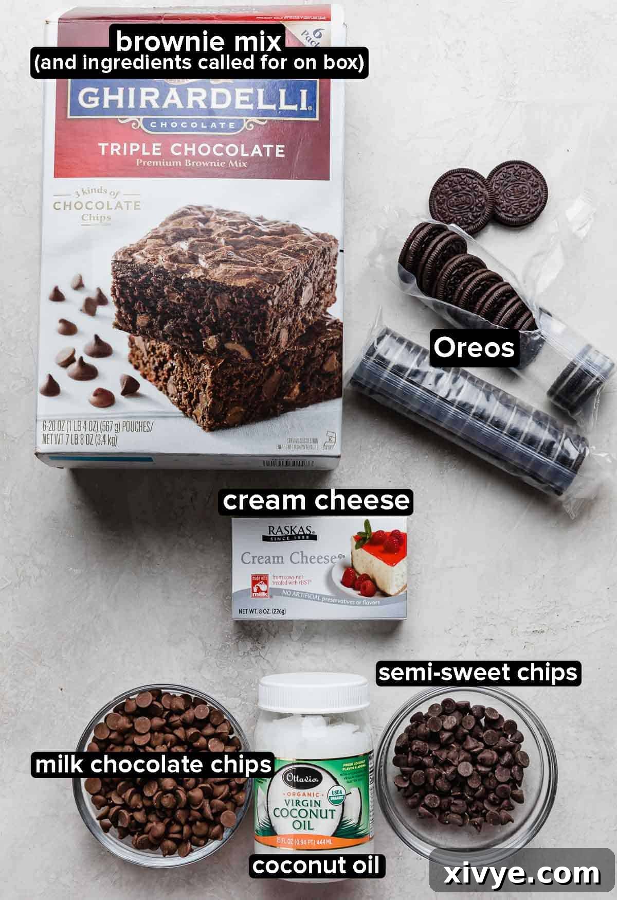 Decadent Oreo Truffle Brownies 3 Oreo Truffle Brownie ingredients on a light gray background: brownie mix, Oreos, cream cheese, chocolate chips, coconut oil.