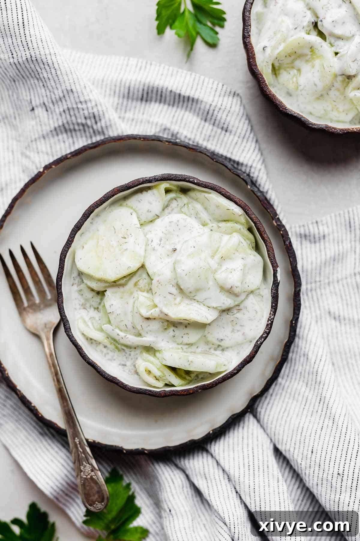Refreshing Cucumber Yogurt 6 A beautifully presented round bowl filled with a creamy cucumber yogurt salad, ready to be enjoyed.