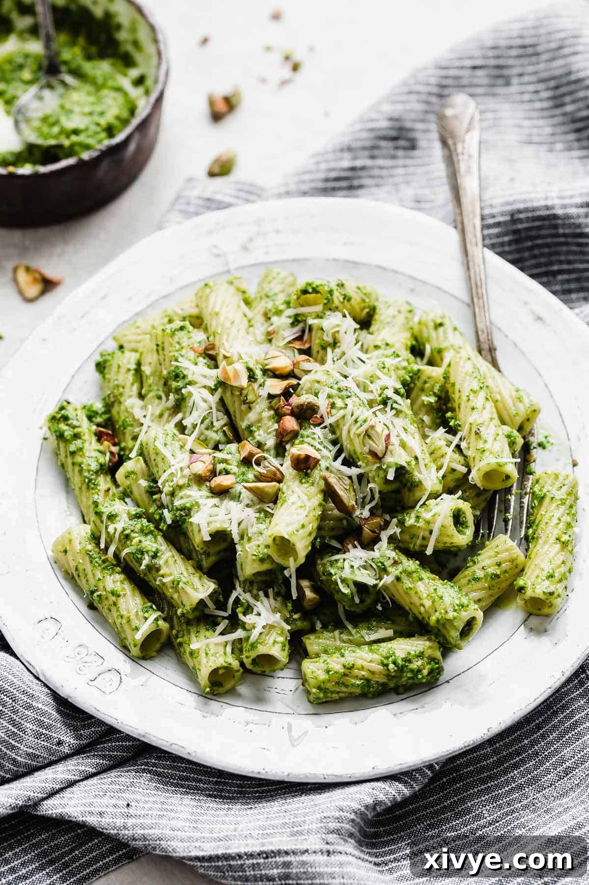 A beautifully plated serving of Kale Pesto Pasta, garnished with fresh herbs, ready to be enjoyed.
