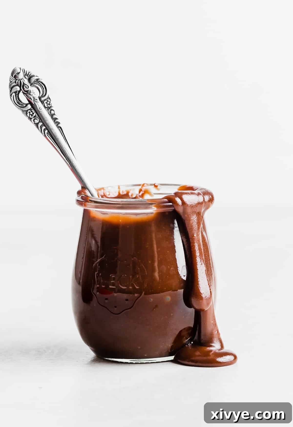 Classic Hot Fudge Sauce 2 Hot Fudge Sauce made with evaporated milk in a glass jar against a white background.