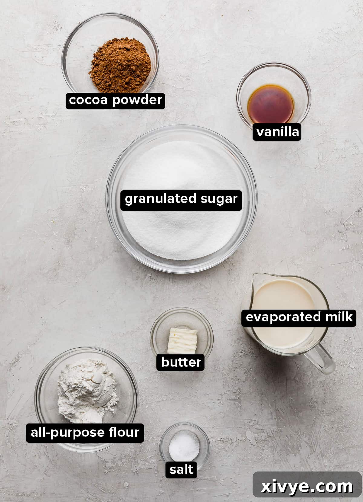 Classic Hot Fudge Sauce 3 Hot Fudge Sauce ingredients in glass bowls on a white marble background.