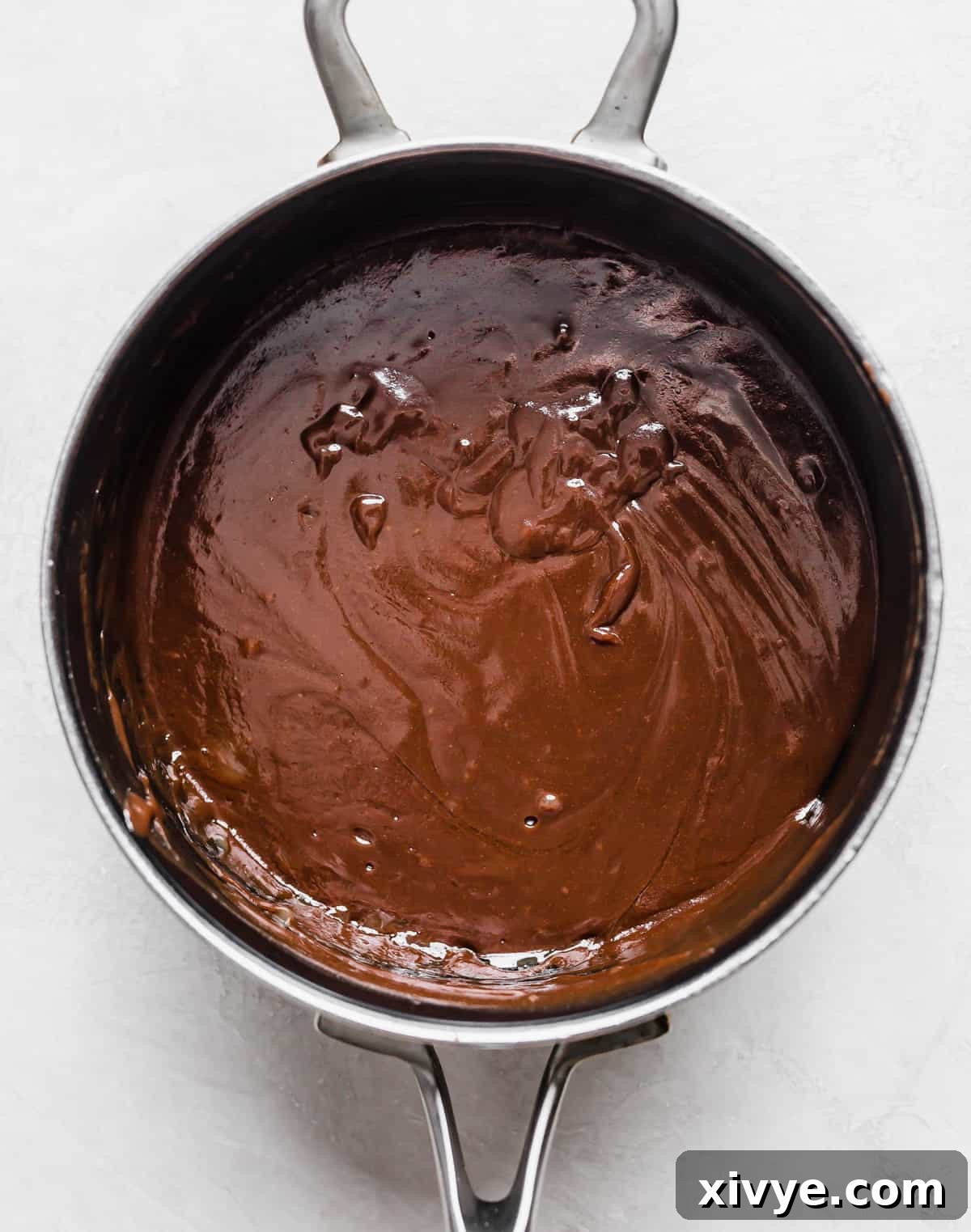 Classic Hot Fudge Sauce 9 Homemade Hot Fudge Sauce made with evaporated milk and cocoa powder, in a saucepan.