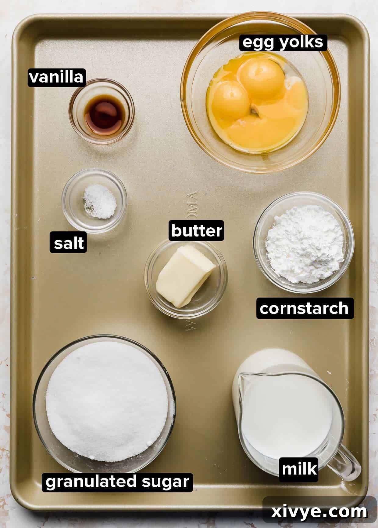 Perfect Homemade Boston Cream Donuts 3 Ingredients used to make Boston Cream donuts filling, portioned into glass bowls on a bronze baking sheet.