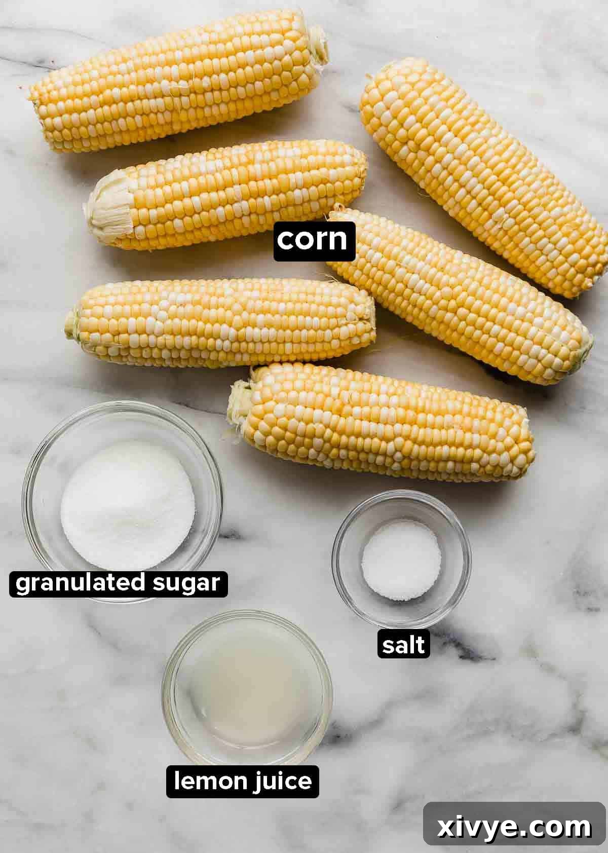 Ingredients used to make sweet boiled corn (or how to boil corn): husked raw corn on the cob, sugar, lemon juice, and salt.