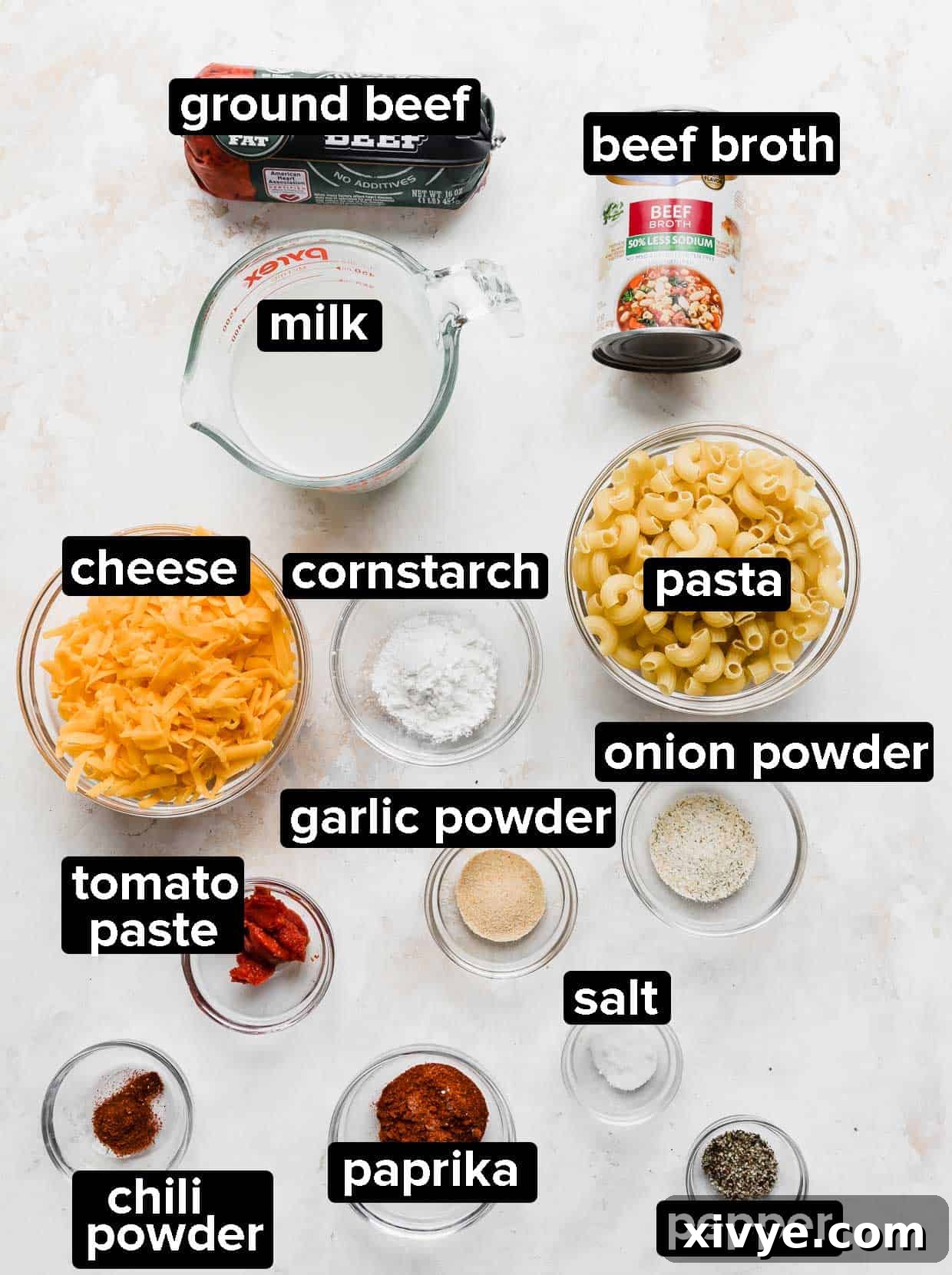 Ultimate Homemade Beef & Mac 3 A vibrant flat lay photo showcasing all the fresh ingredients used to make homemade hamburger helper, including ground beef, pasta, cheese, and various seasonings.