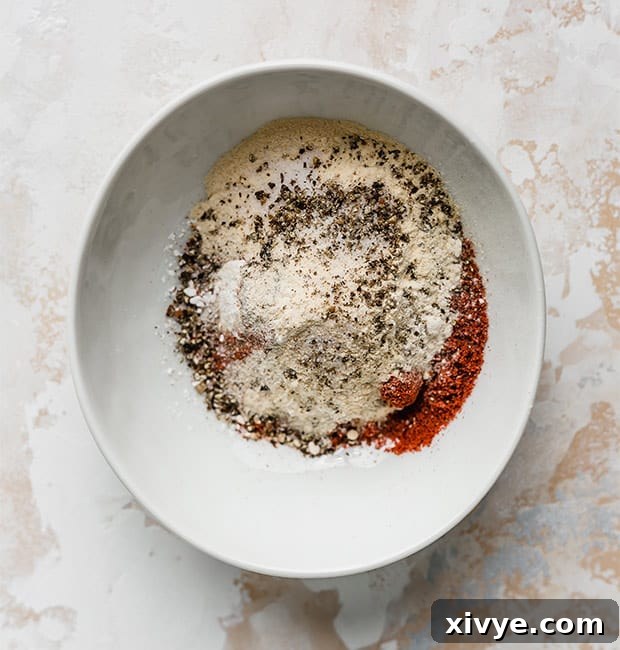 Ultimate Homemade Beef & Mac 4 A small white bowl filled with a blend of dry seasonings, ready to be added to the ground beef for homemade hamburger helper.