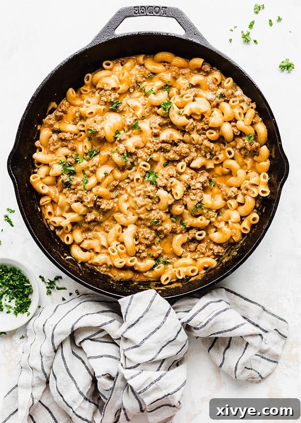 Ultimate Homemade Beef & Mac 9 An overhead photo of a black skillet full of creamy, cheesy macaroni and ground beef pasta, perfectly cooked and ready to serve.