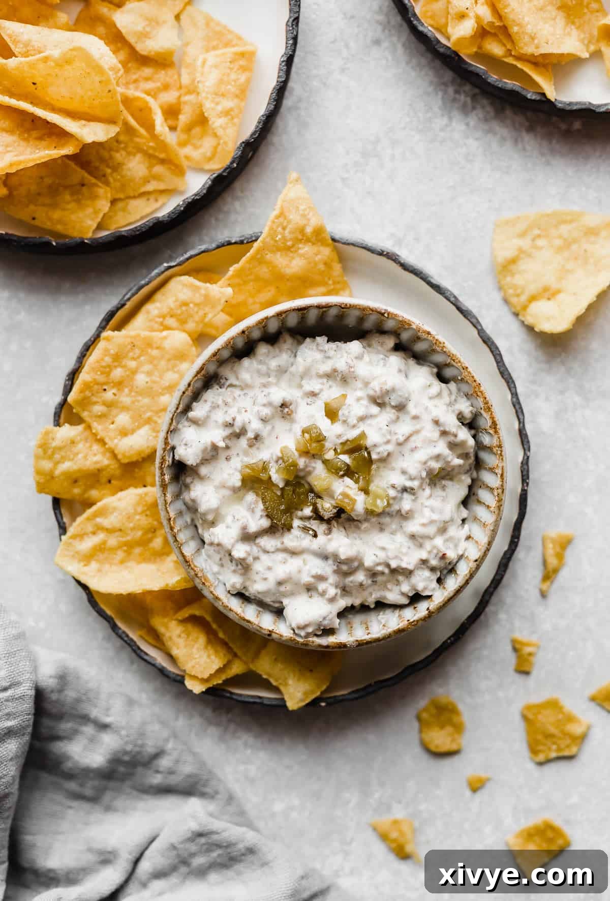 Cream Cheese Sausage Dip in a bowl surrounded by tortilla chips.