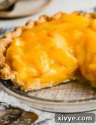 The best Fresh Peach Pie in a pie crust, with two slices removed from the pie.