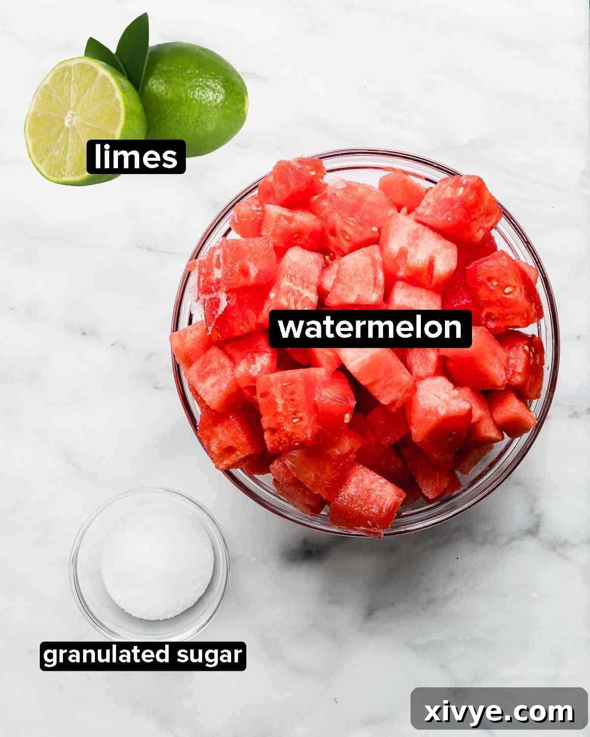 Watermelon Juice ingredients laid out on a white background: fresh watermelon, granulated sugar, and ripe limes.