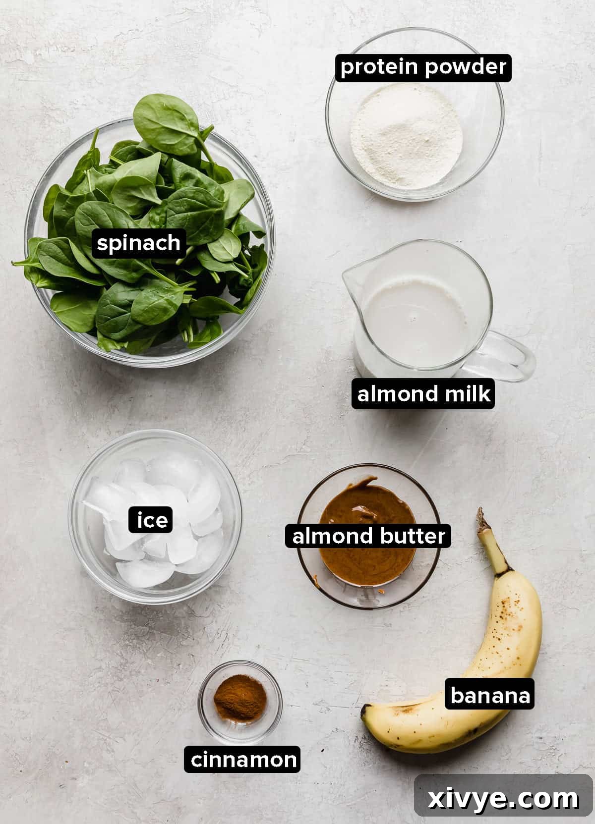 Energizing Banana Spinach Protein Smoothie 3 Green Protein Smoothie ingredients on a gray background.