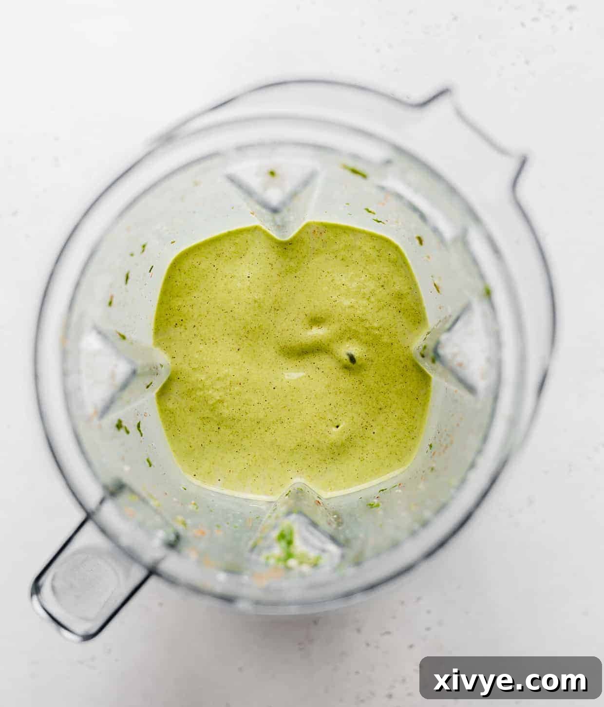 Energizing Banana Spinach Protein Smoothie 5 A pureed healthy green smoothie in a blender.