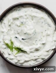 Tzatziki Recipe in a black bowl on a white background.