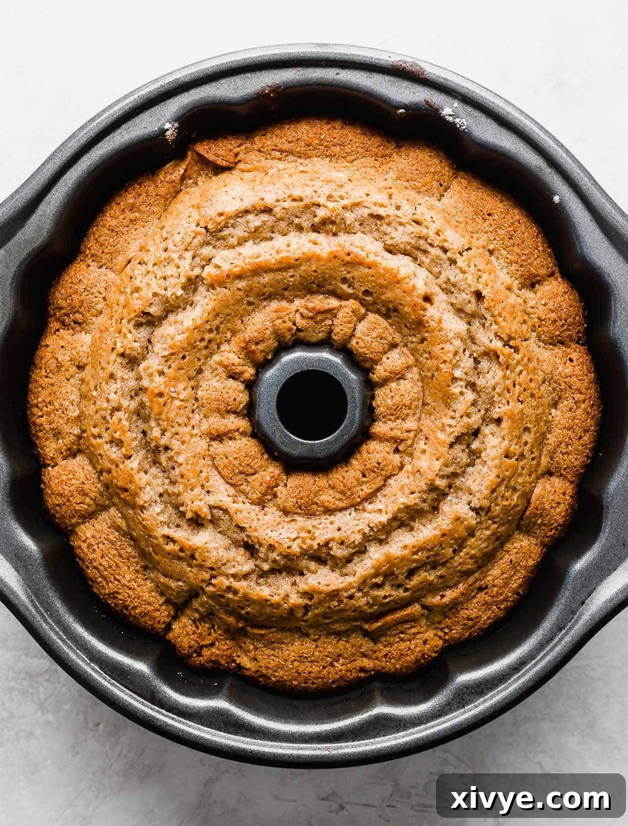A baked Apple Cider Bundt Cake in a bundt pan.