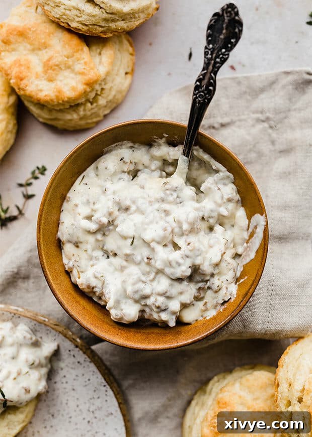 Classic Country Sausage Gravy 5 A bowl full of Homemade Sausage Gravy, garnished with herbs.