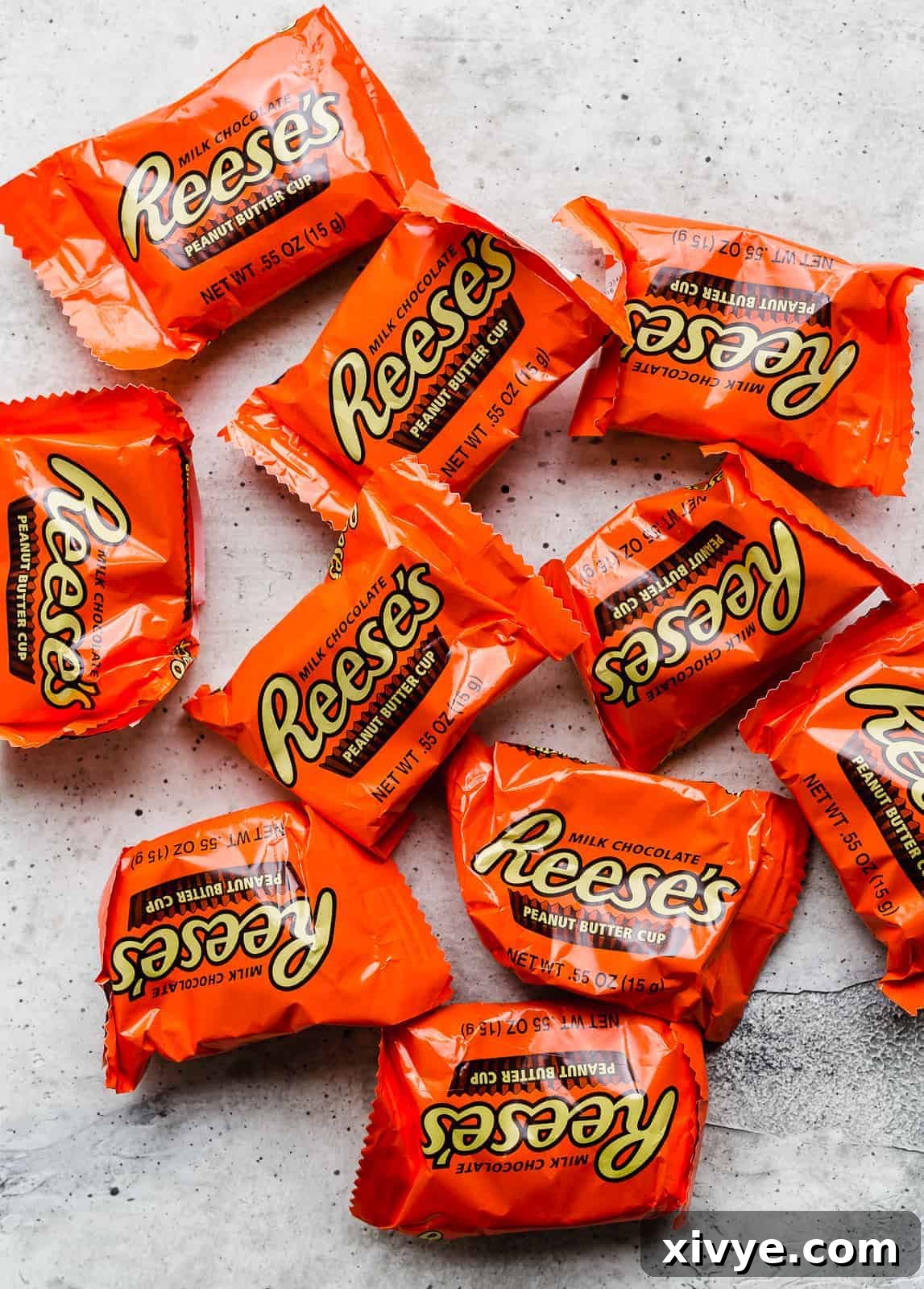 Reese's peanut butter cups in their original orange packaging against a white background.
