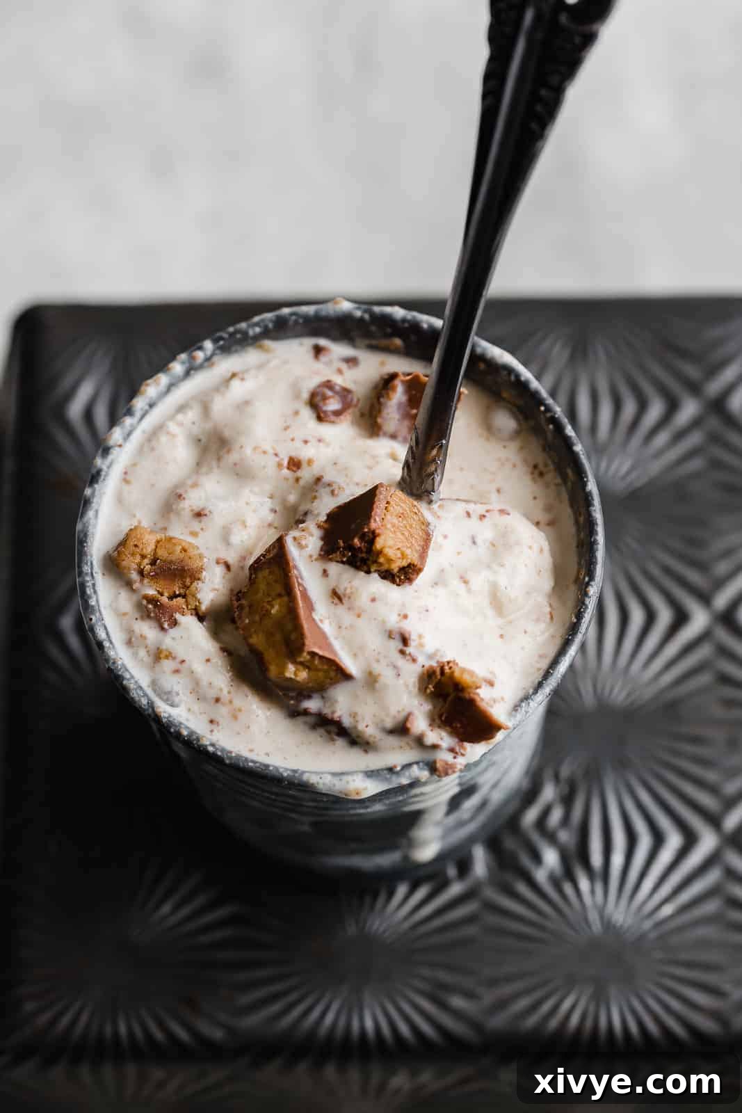 A homemade Reese's blizzard in a metal cup.