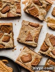 A close up photo of Biscoff Brownies that are topped with chopped Biscoff cookies.