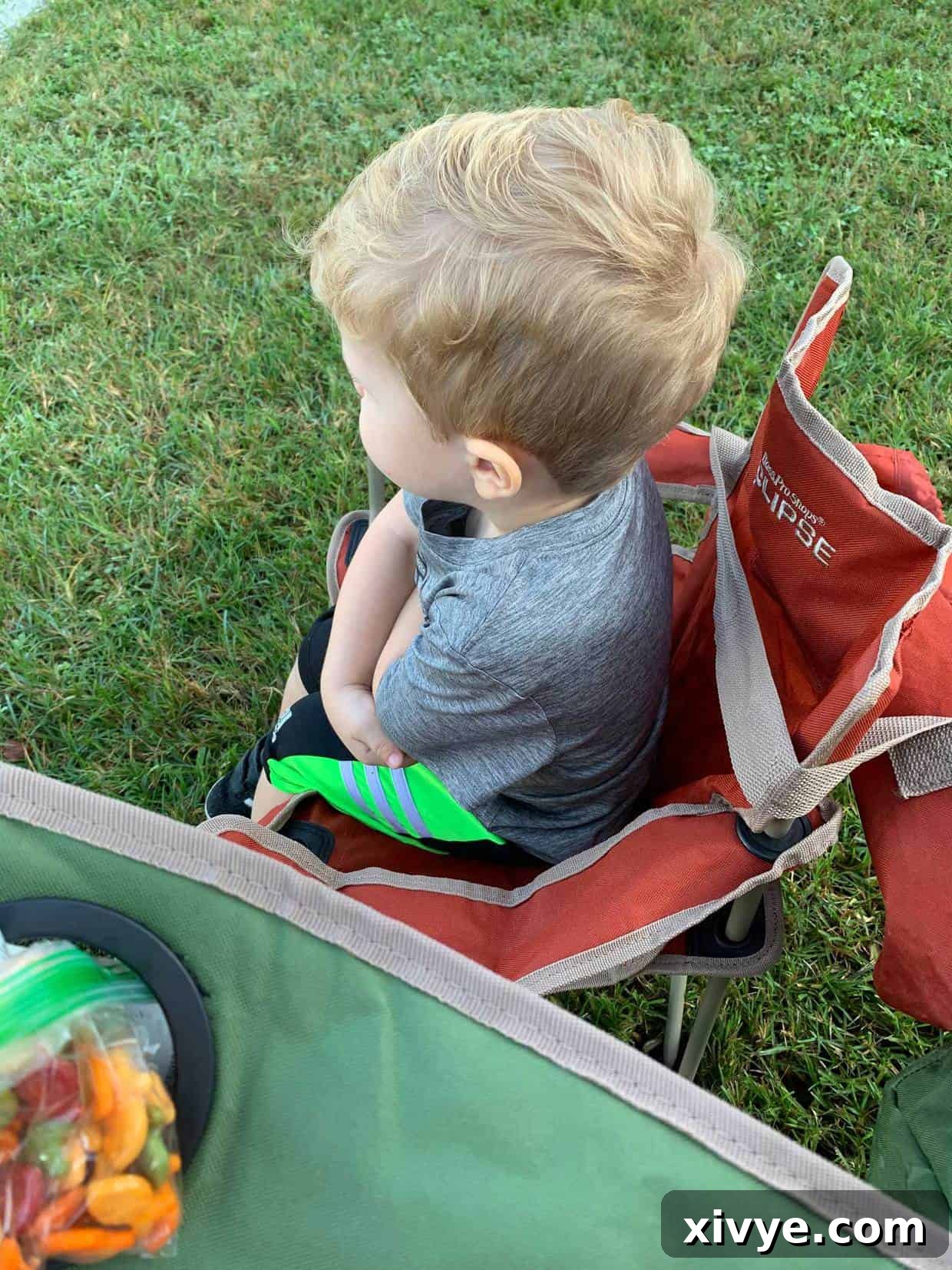 Sweetening Your Wednesday 3 A boy sitting in a chair with his arms folded.