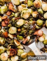A sheet pan with Roasted Brussels Sprouts with Bacon on it.