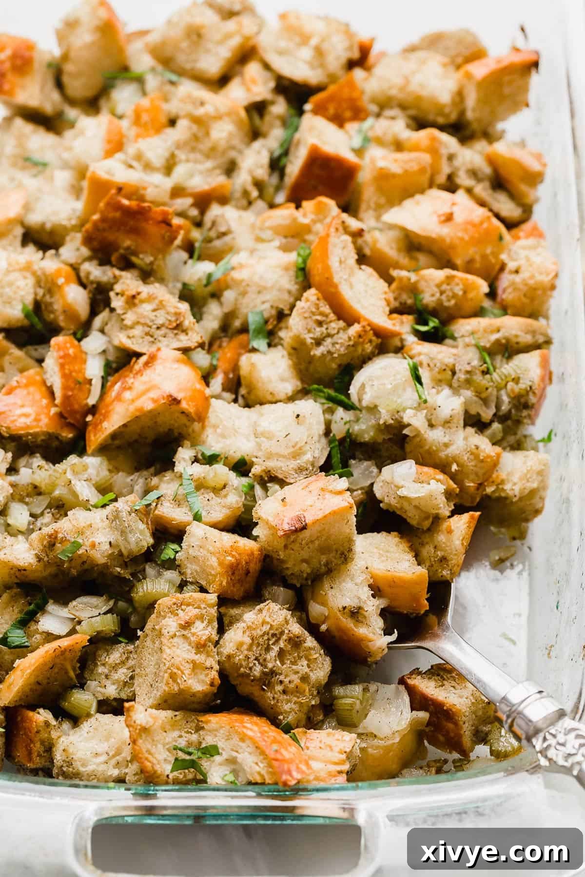 The Ultimate Thanksgiving Stuffing 2 Thanksgiving Stuffing in a glass baking dish.