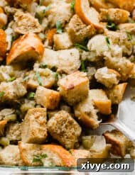 The Ultimate Thanksgiving Stuffing 10 A close up photo of golden baked Thanksgiving Stuffing Recipe. in a baking dish.
