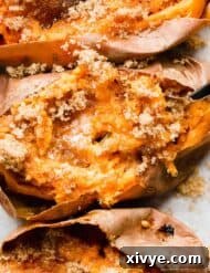 Golden Baked Sweetness 8 A close up of a Baked Sweet Potato topped with butter and brown sugar with a fork mixing the potato flesh.