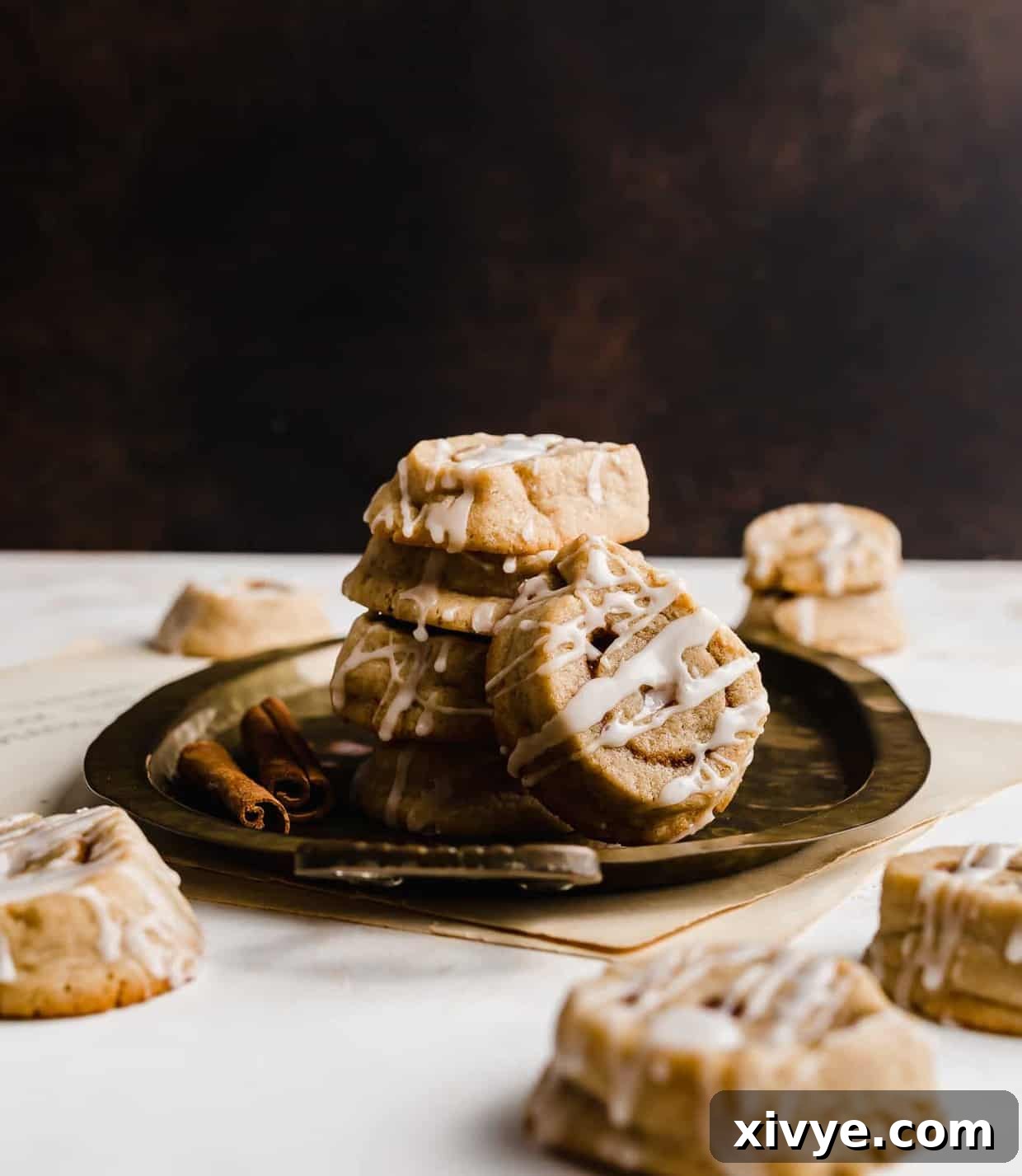 Cinnamon Roll Cookies on a bronze platter, showcasing their perfect swirl and glaze.