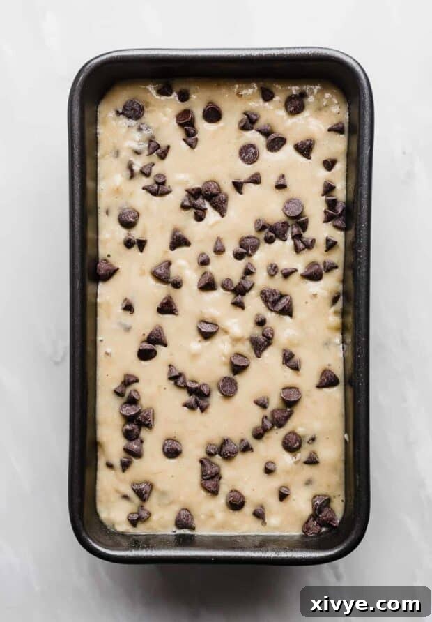 A loaf pan full of Chocolate Chip Banana Bread batter.