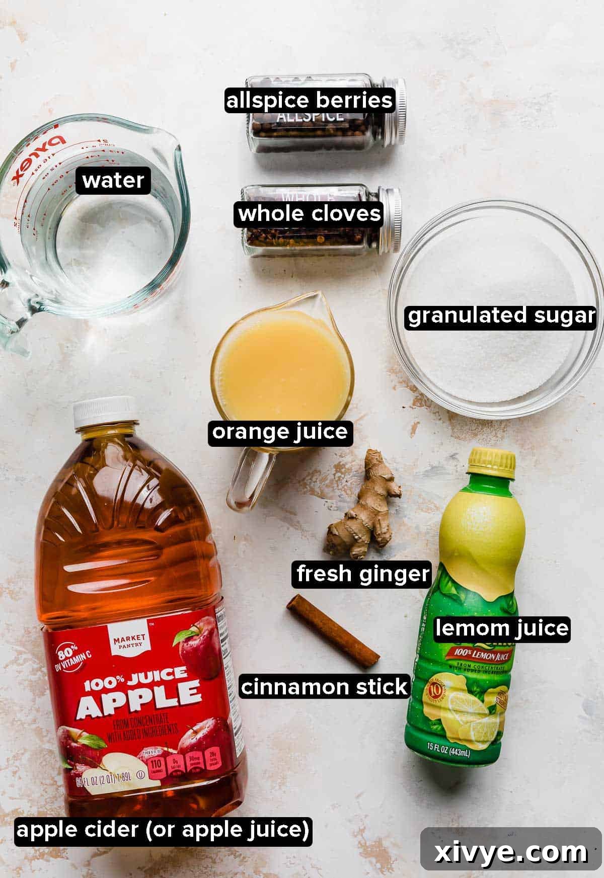 Homemade wassail ingredients on a white textured background: apple cider or apple juice, orange juice, lemon juice, water, sugar, and spices.