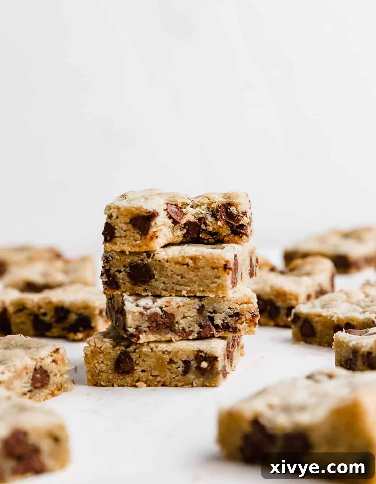 A stack of 4 Chocolate Chip Cookie Bars against a white background.