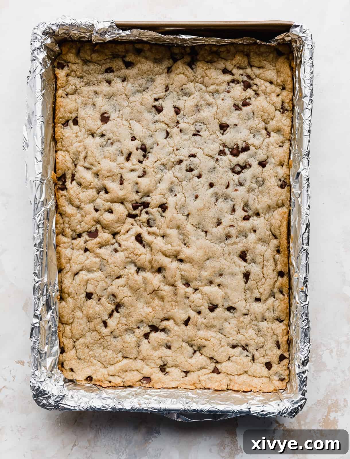 Chocolate Chip Cookie Bars in a foil lined 9x13 inch pan.