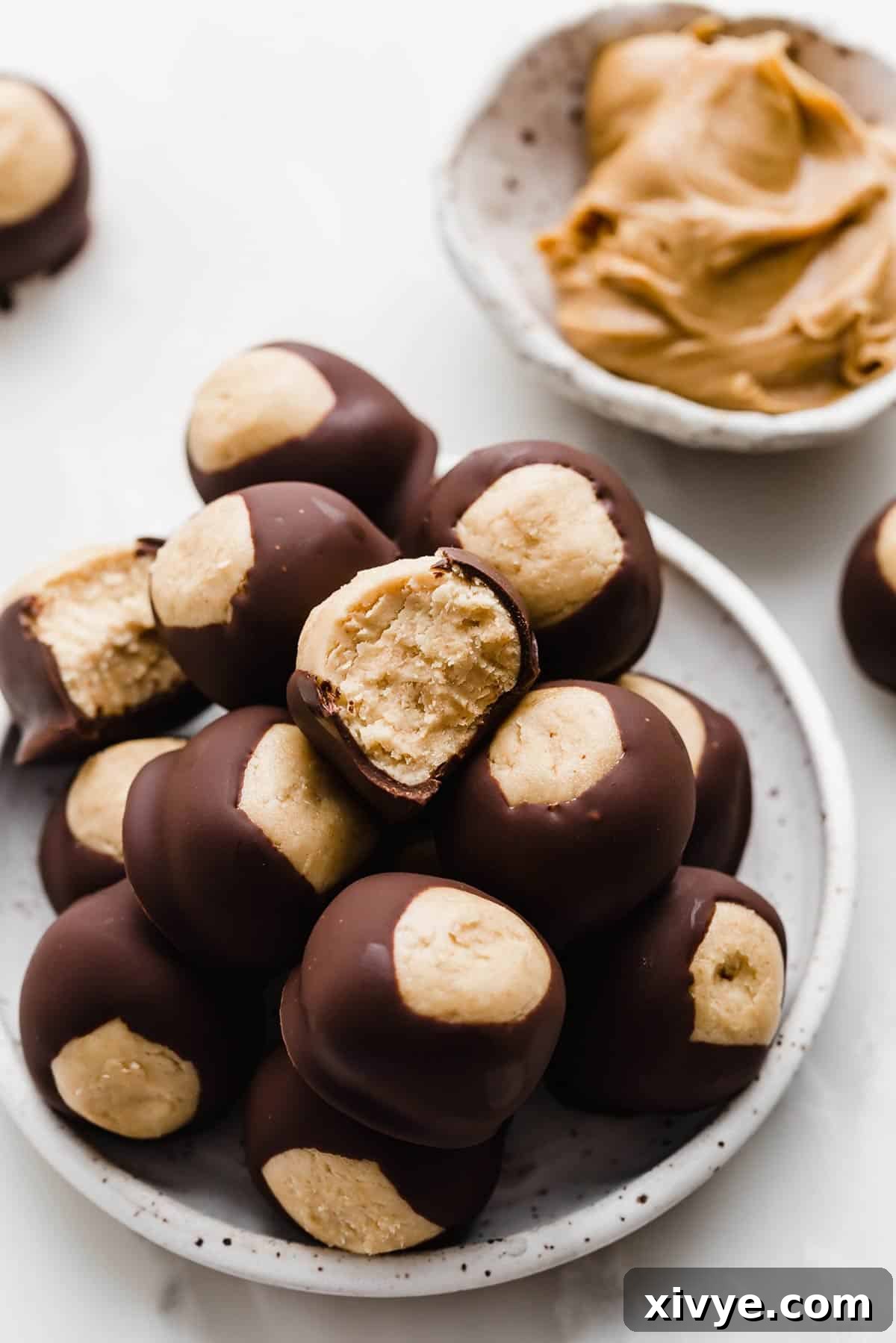 A white plate topped with homemade Buckeyes.