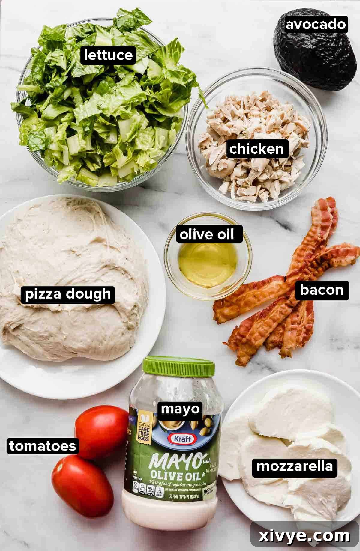 CPK Club Pizza ingredients on a white background: pizza dough, bacon, tomatoes, mayo, mozzarella, lettuce, chicken, and avocado.
