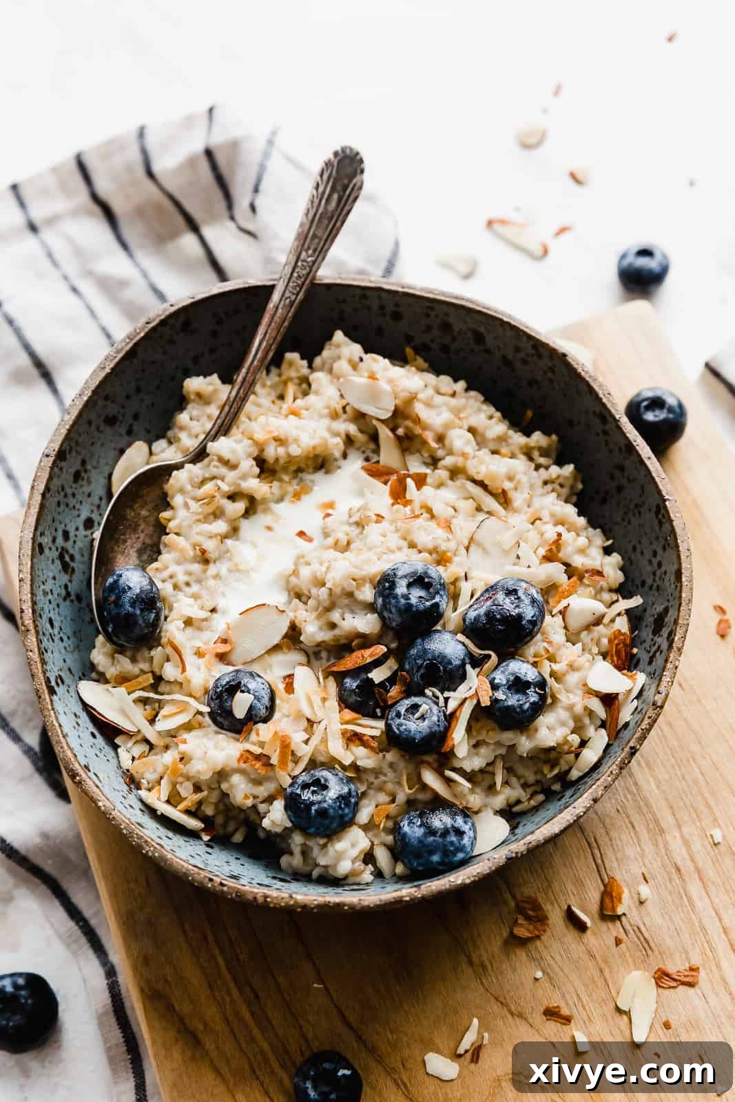 The Perfect Steel Cut Oats 9 A bowl of steel cut oats topped with blueberries, almonds, and milk.