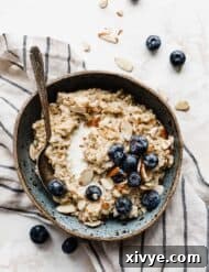 The Perfect Steel Cut Oats 10 A bowl of Steel Cut Oats on a white background with blueberries and nuts.