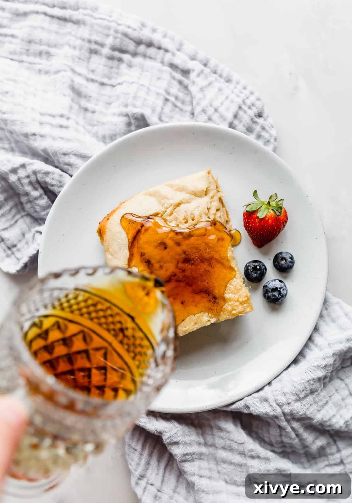 Wholesome German Pancake Delight 3 Overhead photo of syrup being poured over a German pancake.