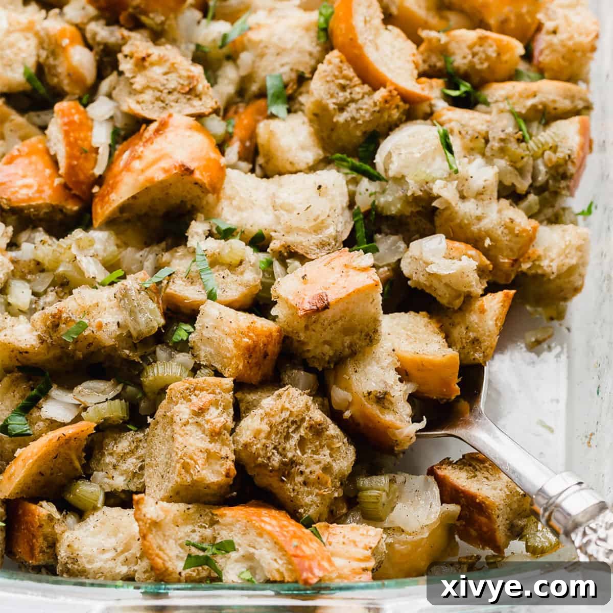 A close up photo of golden baked Thanksgiving Stuffing Recipe. in a baking dish.