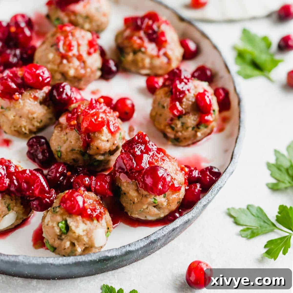 Baked turkey meatballs topped with cranberry chutney sauce.